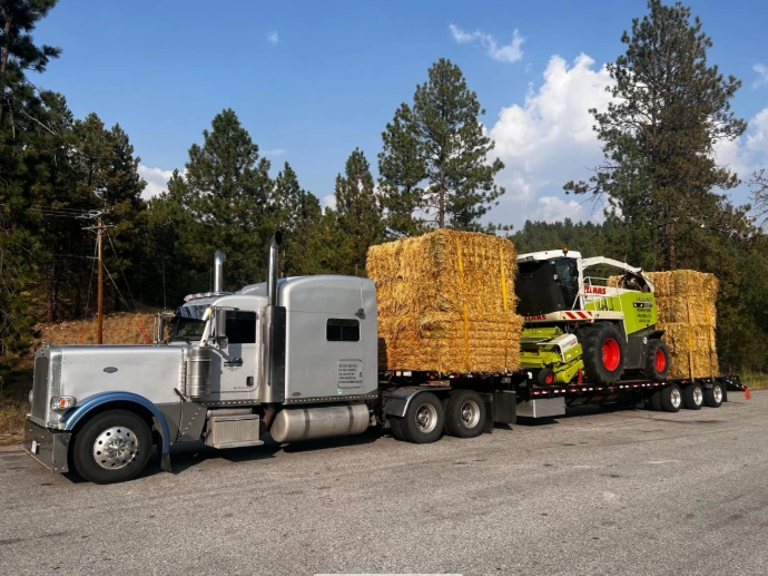 Truck hauling hay and equipment